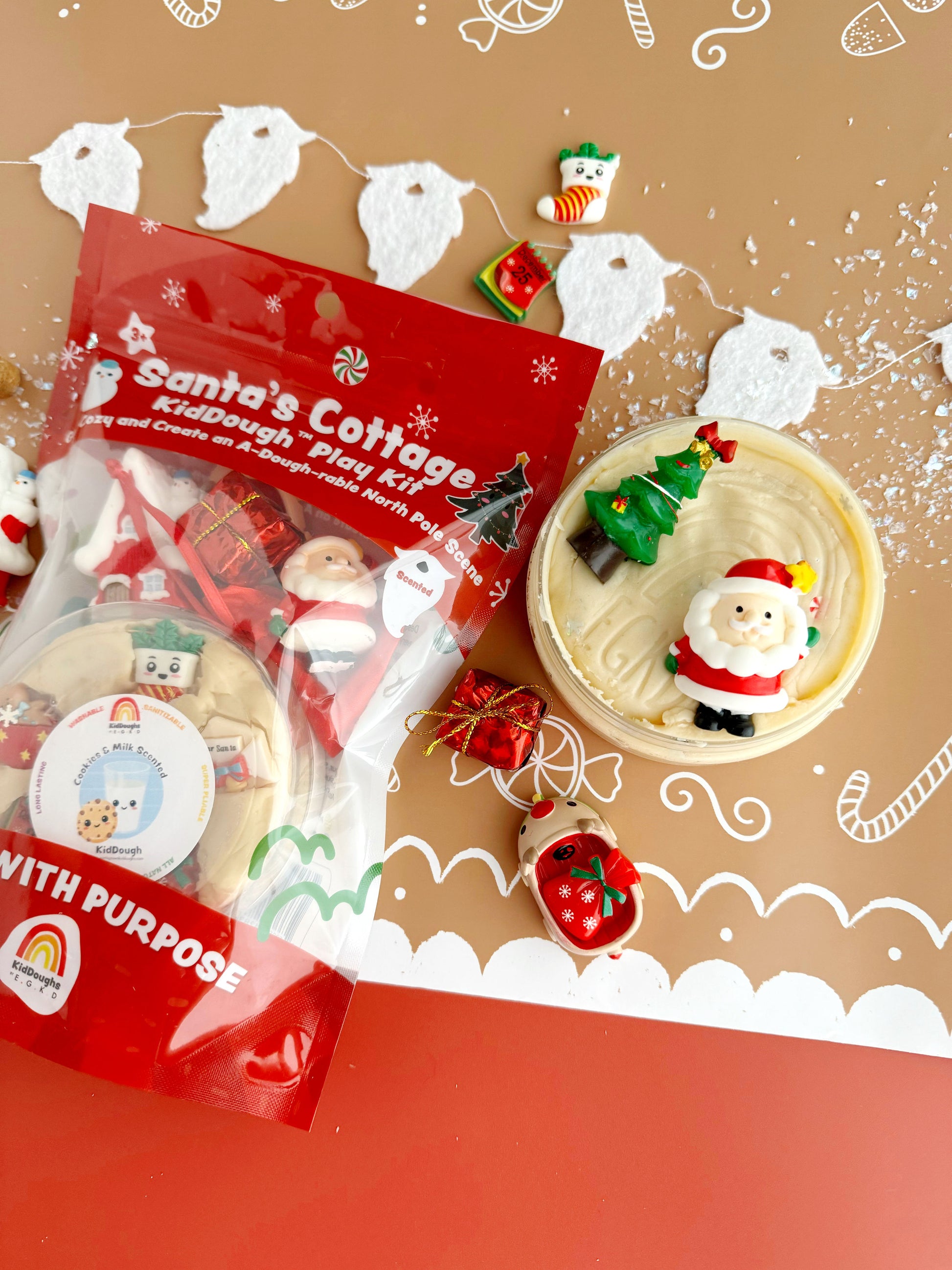 Santa's Cottage play kit with Christmas-themed items on a decorative background