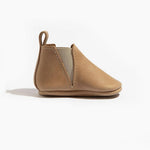Tan baby shoe on a white background