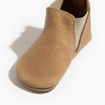 Tan baby shoe on a white background