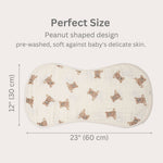 Peanut-shaped baby burp cloth with teddy bear pattern and measurements on a white background