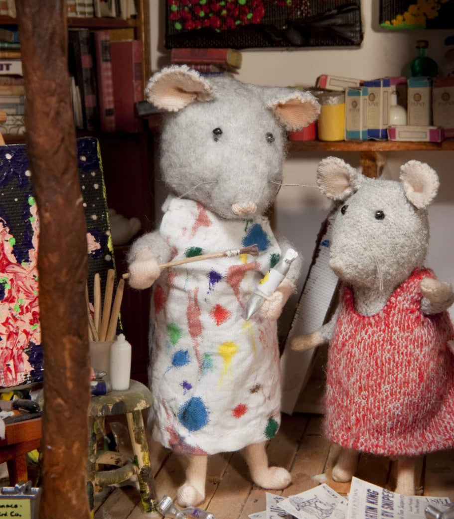 The artist and Julia in a room with books and art supplies