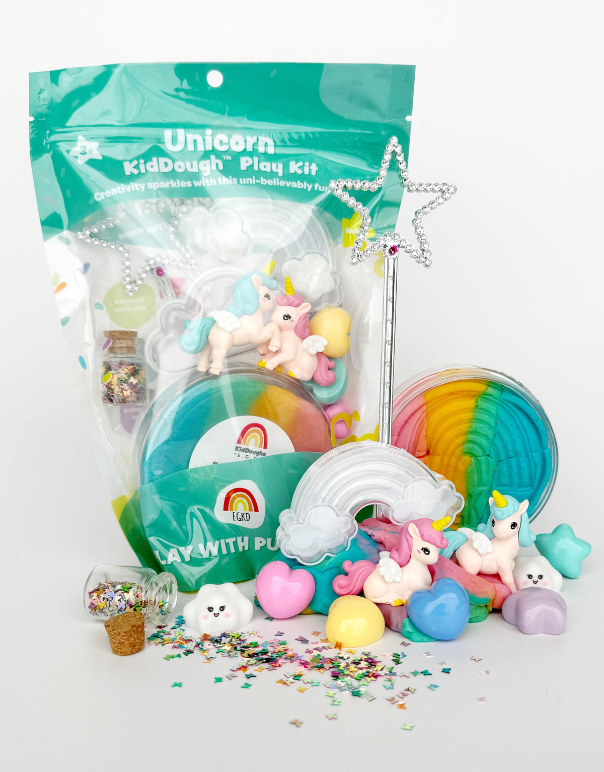 Unicorn-themed kidough play kit with rainbow colors and star decorations on a white background