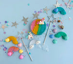 Colorful unicorn-themed candies and decorations on a blue background