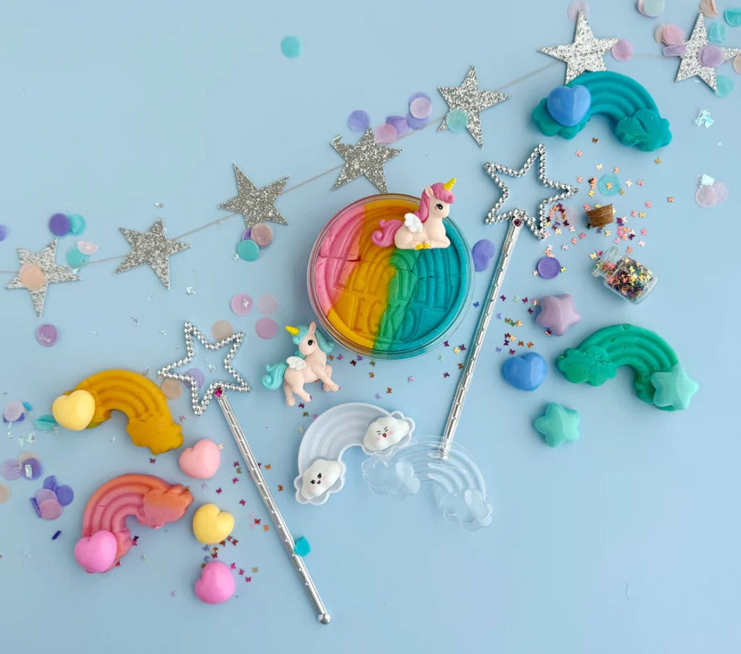 Colorful unicorn-themed candies and decorations on a blue background