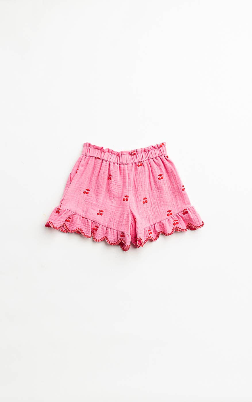 Girls Pink shorts with ruffled details on a white background