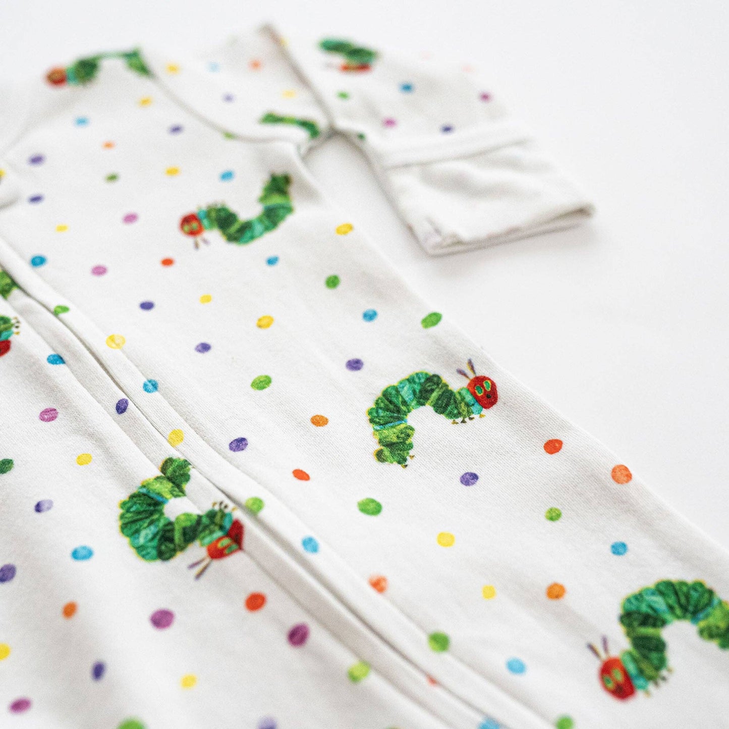 baby footie set with colorful polka dots and caterpillar design on a white background