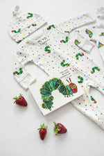 Baby clothing set with 'The Very Hungry Caterpillar' book on a white background
